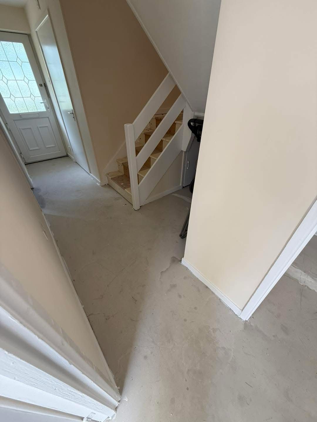 Hallway before, no carpet, bare floorboards