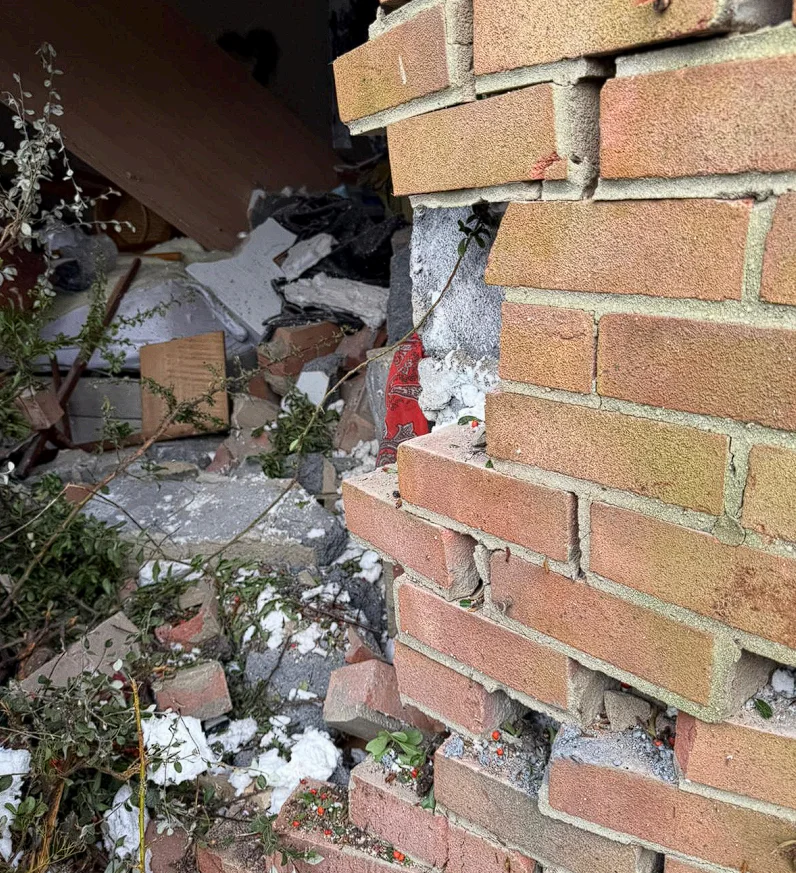 Close up of the smashed external wall at the Oxford property after the vehicle impact