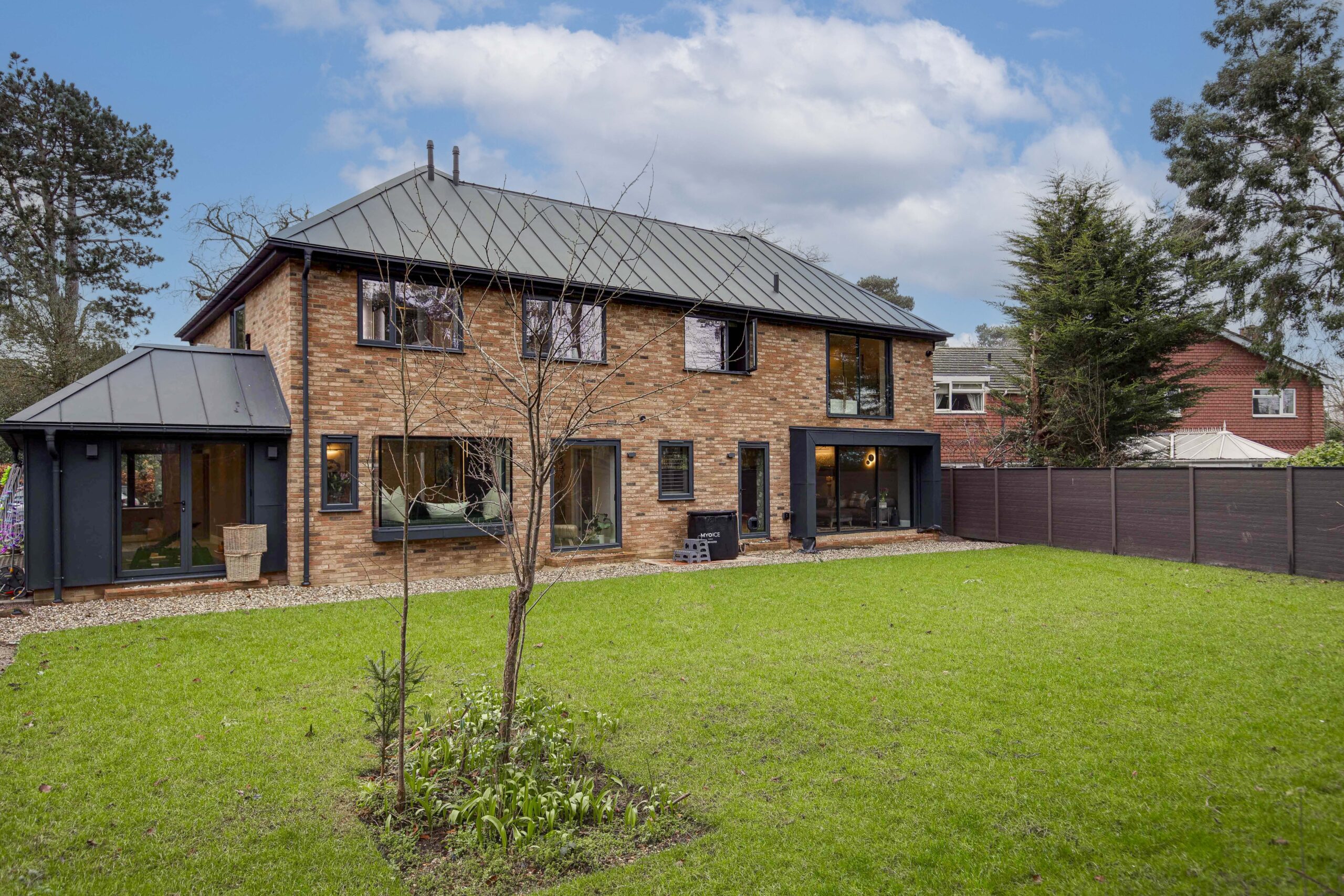 The completed Woodfield Road extension and rebuilt house against open sky